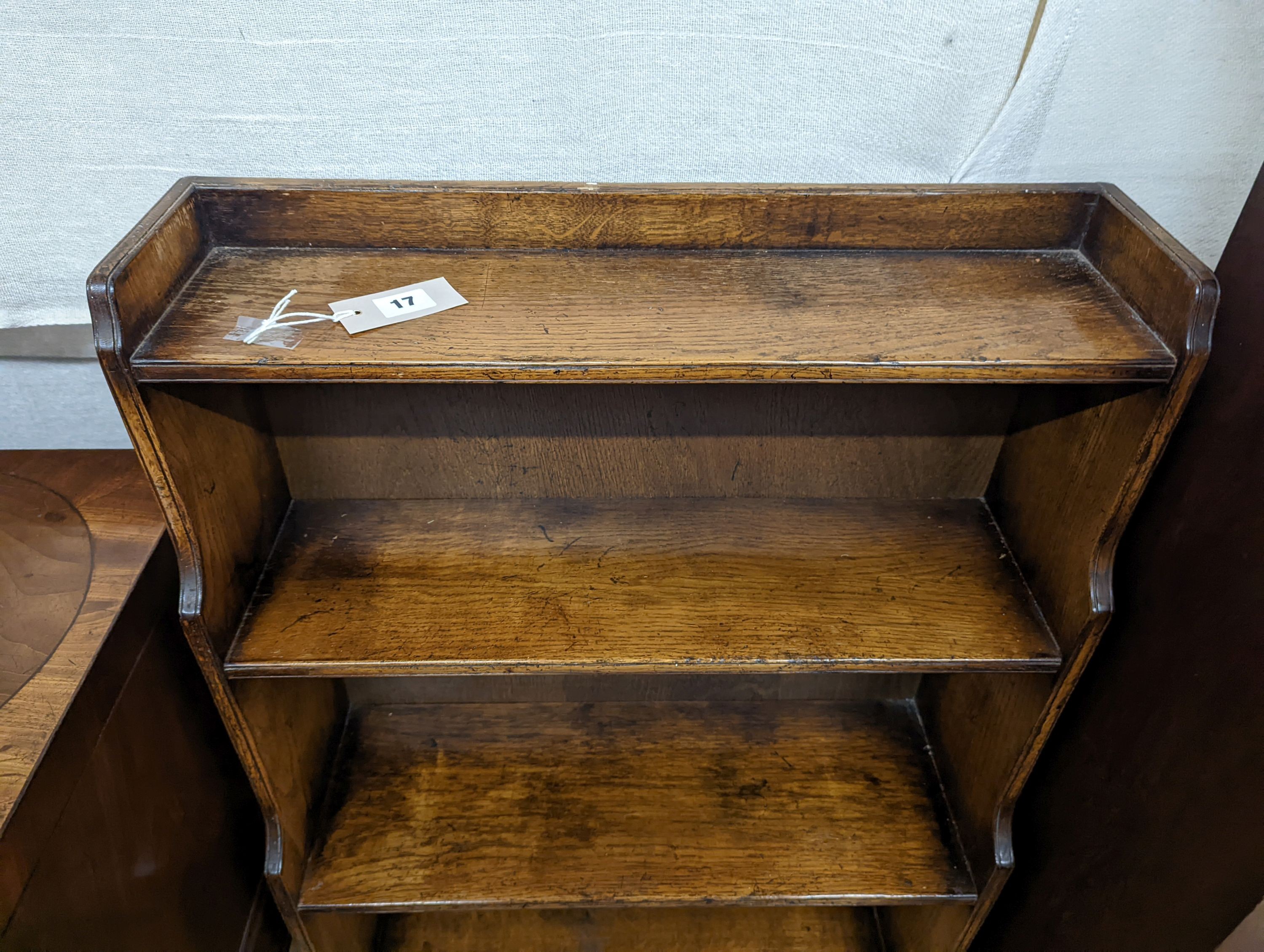 A reproduction 18th century style oak graduated open bookcase, width 60cm, depth 27cm, height 104cm